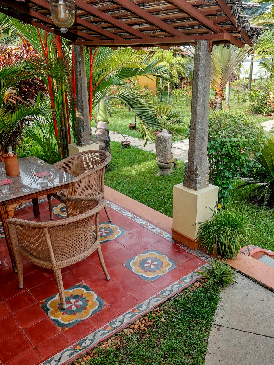 A table for two on a tiled verandah, looking out to the garden